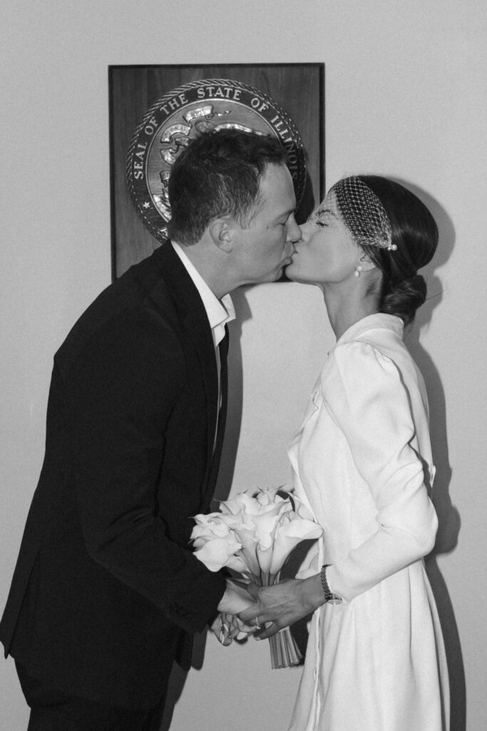 Newlyweds share a first kiss after saying their vows.