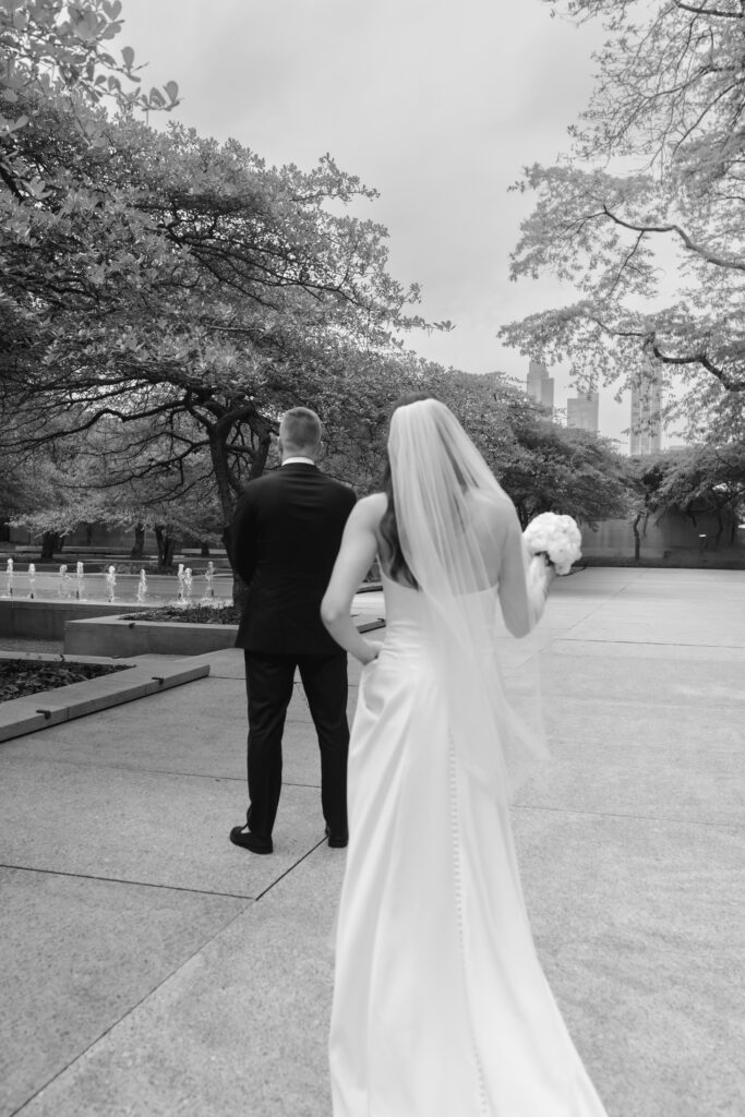 Groom sees bride for the first time at the Art Institute South Gardens during their intimate Chicago wedding