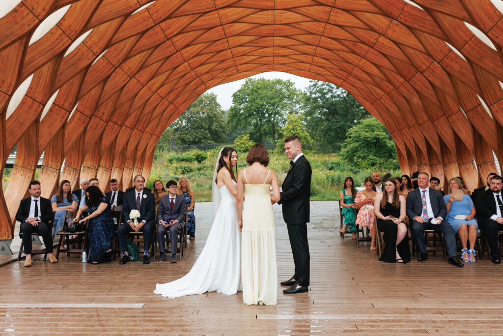 Bride and groom exchange vows at the Honeycomb Pavilion in Lincoln Park during their intimate Chicago wedding