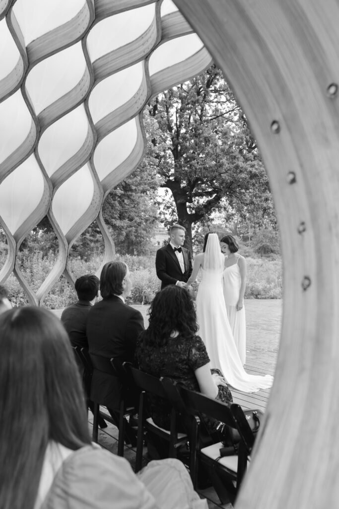 Bride and groom exchange vows at the Honeycomb Pavilion in Lincoln Park during their intimate Chicago wedding
