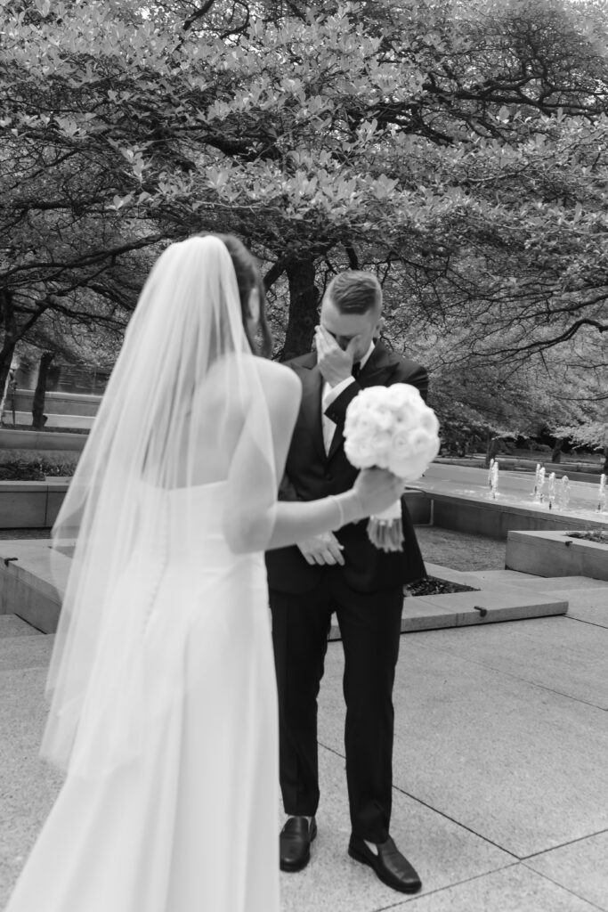 Groom sees bride for the first time at the Art Institute South Gardens during their intimate Chicago wedding
