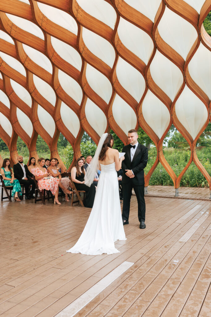 Bride and groom exchange vows at the Honeycomb Pavilion in Lincoln Park during their intimate Chicago wedding