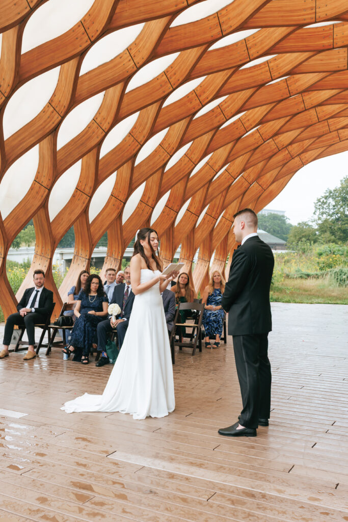Bride and groom exchange vows at the Honeycomb Pavilion in Lincoln Park during their intimate Chicago wedding