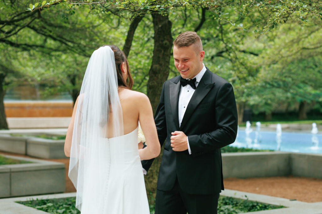 Groom sees bride for the first time at the Art Institute South Gardens during their intimate Chicago wedding