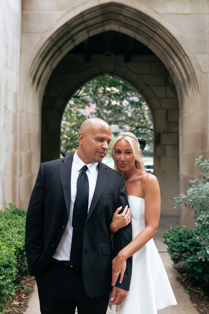 Romantic engagement photo under stone archway at 4th Presbyterian Church, Chicago