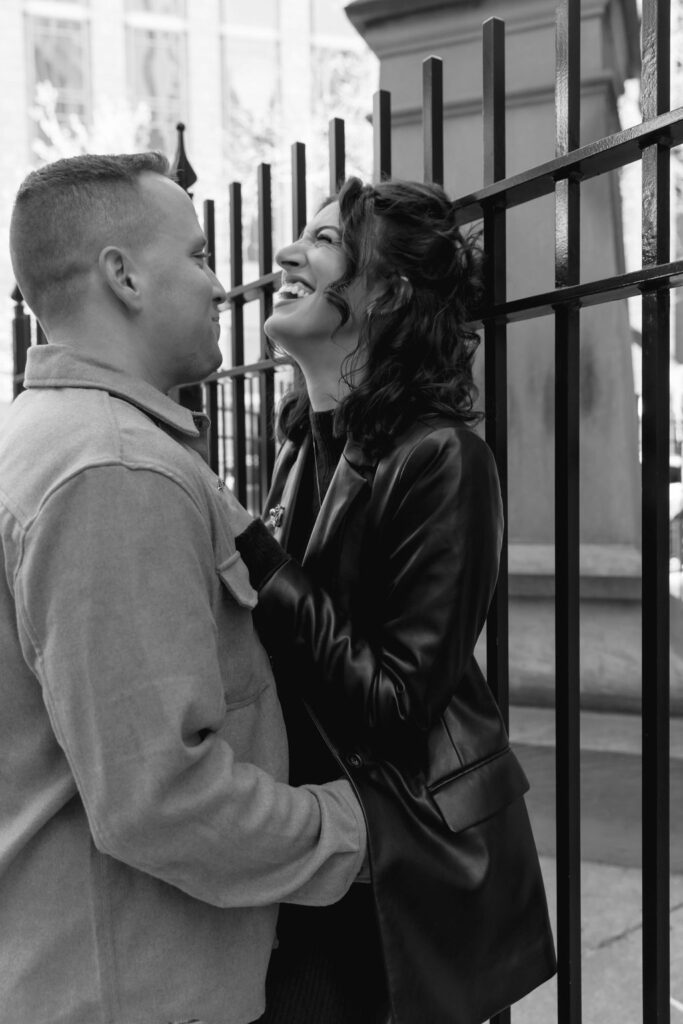 Candid black and white photo of a couple embracing during their Chicago engagement session.